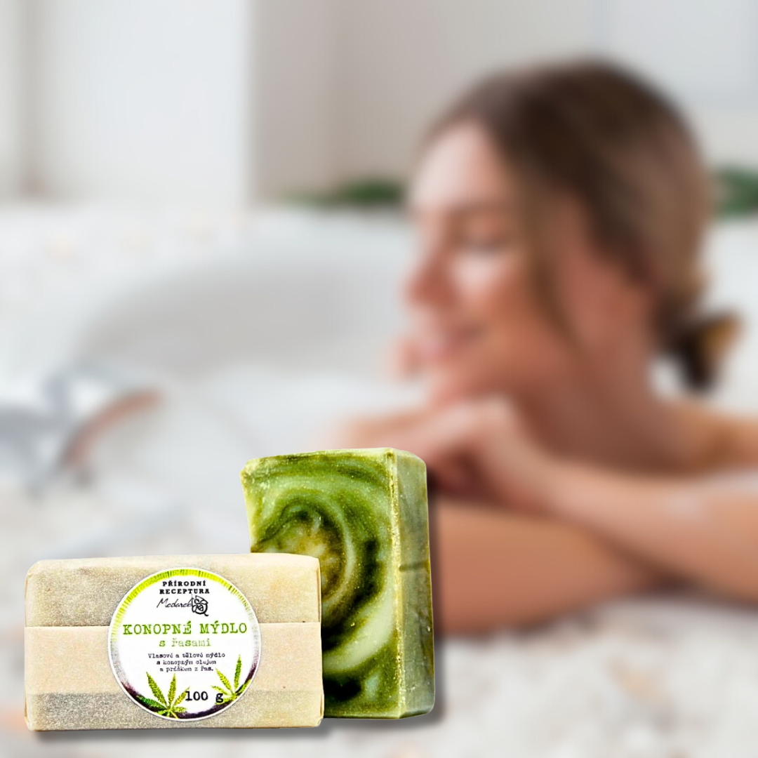 Medarek Hemp Soap (100 g) — two bars with a green swirl; blurred woman bathing in the background